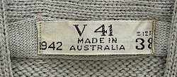 Label located on the inside collar of the Australian made V‐neck sweater shown above. The letter V indicates the sweater was made in the state of Victoria.  Australian made clothing usually had labels that displayed a code consisting of a letter followed by numbers where the letter stood for the state where the garment was manufactured, and the numbers represented a specific manufacturer. Also included was the contract year, size, and Made in Australia.