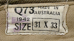 Label located on the inside waistband of the enlisted man's trousers shown to the left and right.  The Q73 was a manufacturer's code with the Q indicating the location was in the state of Queensland and the 73 representing a specific contractor there.