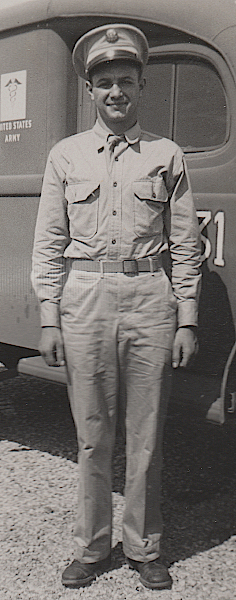 An ambulance driver at Fort Pickett, Virginia in August 1942 wears the summer service uniform topped with a khaki cotton service cap.  Per regulations, the necktie is worn tucked between the 2nd and 3rd buttons of the shirt.  Note the front button placket on the shirt.