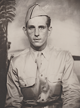 Pvt. John Sabon in Hawaii during 1942.  The khaki cotton shirt had mitered pockets and flaps to prevent corners from sticking out.  His field cap (a.k.a. garrison cap) is trimmed with scarlet branch of service piping indicating he is assigned to an artillery unit.