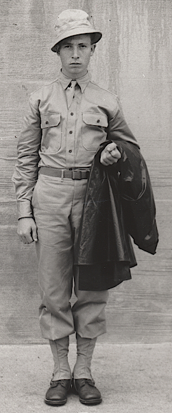 U.S. Army photograph published 20 June 1941 showing the dismounted khaki cotton field uniform. The khaki shirt and trousers are worn with a cotton field hat and canvas leggings. An unknown type of raincoat is draped over the soldier's arm. Raincoats were considered an essential part of the field uniform and were carried in the field pack when not in use.