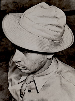 This ACME photo published 25 March 1942 shows a soldier wearing the khaki cotton field hat.  The hat offered the soldier protection against the sun and rain and could be conveniently folded and tucked into a pocket when not needed.  The brim could be worn up or down in the front or back as desired.