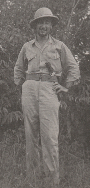 Army Air Force ground personnel in the bush near Waller Field, Trinidad.  This man wears the khaki cotton convertible collar shirt open at the neck.  He also wears a cloth covered fiber helmet for protection from the sun and surrounding brush.  The convertible collar was introduced in 1941 to improve the look and comfort of the khaki shirt when worn with an open collar in hot weather.  Note the falling collar that lays flat when open and the absence of a front button placket.