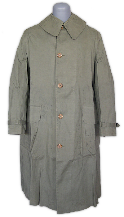 Enlisted men's dismounted M‐1938 rubberized raincoat (specification QMC 20‐104A, 16 January 1940). The M‐1938 raincoat featured a standing and rolling collar with throat latch, outside bellows pockets with slanted flaps, back vent, interior storm flap, and tightening straps on each sleeve.   The raincoat was an essential article of field clothing and was carried in the field pack.  Pre‐war raincoats were made of rubberized fabric and were fairly elaborate designs.  In early 1942, a simplified raincoat made with synthetic resin coated fabric began replacing the rubberized type.