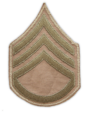 Cotton staff sergeant chevrons (3rd grade).  Another type of washable chevron worn on the khaki uniform during the WW2 era.  Considered unofficial, this type was made by embroidering olive‐drab chevrons on a khaki cotton twill background.