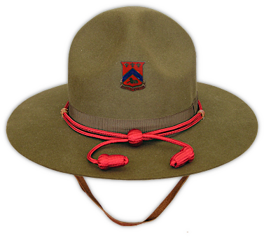 Olive‐drab service hat (Specification QMC 8‐22A, 1940).  This was the approved field hat for the khaki cotton uniform in the pre‐war years and is sometimes referred to as a campaign hat.  Its awkwardness in confined spaces and the difficulty of storing and maintaining the hat helped cause it to fall out of favor as WW2 approached.  It was gradually replaced by the khaki cotton field hat and fiber helmet shown above.  Made of beaver colored felt, the design includes a 5 ¼‐inch "Montana Peak", four indentations on the crown, a ⅜‐inch adjustable leather chin strap, and an olive‐drab band and bow 15/16‐inch in width.    A branch of service colored cord with acorns and keeper was worn around the base of the crown.  Distinctive unit insignia was typically worn attached to the front vent hole, or occasionally the service cap badge.