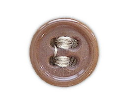 Plastic button used on the khaki cotton shirt shown below.  The shirt had a total of eleven 24‐ligne buttons.  Seven were used for the front opening, one for each pocket, and one for each cuff.