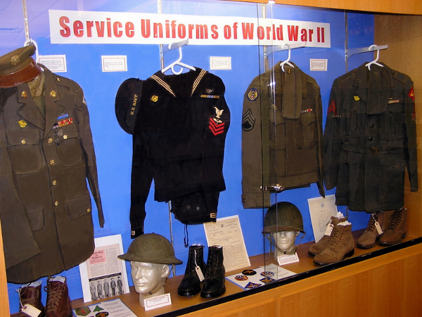 View of Niles Public Library "Service Uniforms of World War II" 2011 Memorial Day display showing U.S. Enlisted Mens wool service uniforms (L-R) Army, Navy, Army Air Force, and Marine Corps.