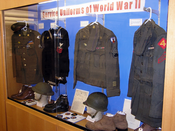 View of Niles Public Library "Service Uniforms of World War II" 2011 Memorial Day display showing U.S. Enlisted Mens wool service uniforms (L-R) Army, Navy, Army Air Force, and Marine Corps.