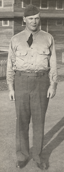 Enlisted man wearing the wool garrison uniform sans coat with khaki cotton shirt and field cap. The khaki cotton shirt was worn in lieu of the flannel shirt when warmer conditions required a lighter shirt. Originally, a worsted wool shirt with a plain weave was used for this purpose until the cotton shirt replaced it in 1941. Note the front button placket indicating the specification 6‐241 shirt as shown above.