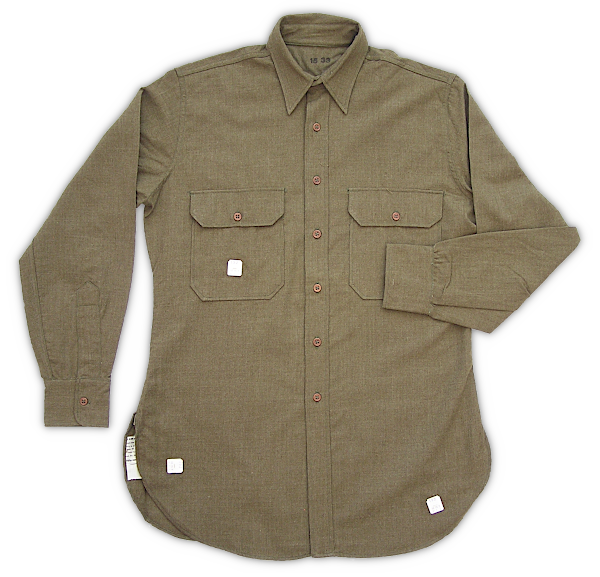 Enlisted man's worsted shirt (Shirts, Worsted, Olive‐drab; Specification QMC 8‐108, 2 August 1937). A dress style shirt with a standing and falling collar, front button placket, shirt style cuffs, two patch pockets with mitered corners, and a rear yoke. The fabric was worsted wool made in olive‐drab shade 31 and worn in place of the flannel shirt in warmer weather. This shirt was eliminated by the end of 1940 and replaced by the khaki cotton shirt shown below.