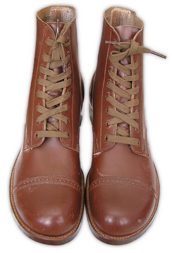 US Army service shoes (specification QMC 9‐6E, 5 March 1934). Service shoes were made in Army russet shade, constructed in a blucher pattern, had unlined cowhide uppers, leather outsoles, and stacked leather heels. The Goodyear welt method was used to attach the soles to the uppers. Rubber heels were added to the service shoe in 1940 and then in late 1941 rubber taps were added to the outsoles forward of the shank.