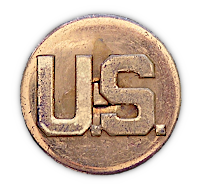 Close‐up view of the right collar insignia for the enlisted man's wool service coat shown below. Army regulations of 1941 stipulated a 1‐inch diameter disk with the "U.S." being a separate piece superimposed on the disk. The disk was attached to the collar via a screw post and nut. Non‐federalized units usually had their state abbreviation superimposed on the "U.S.". Occasionally, regiment numbers were displayed below the "U.S.".